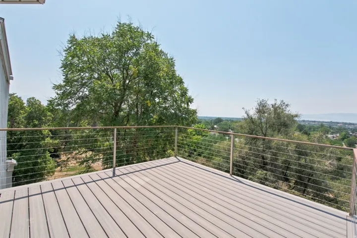 Rooftop deck featuring composite decking and a cable railing system