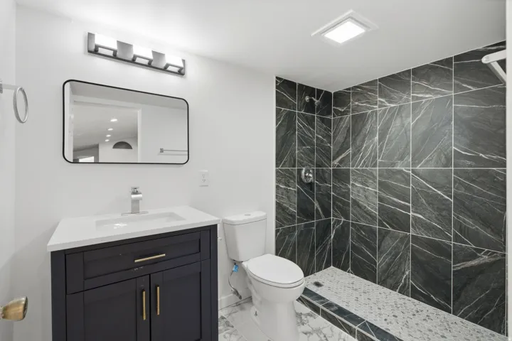 Vanity with white countertop, chrome faucet, and rectangular undermount sink