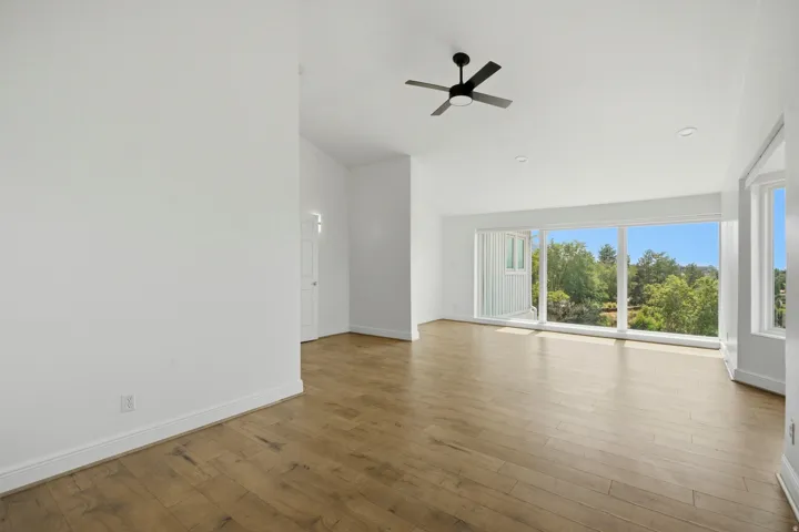 Wood-finish flooring, recessed lighting, and a modern ceiling fan