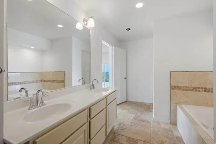 Dual vanity with chrome fixtures and integrated sinks
