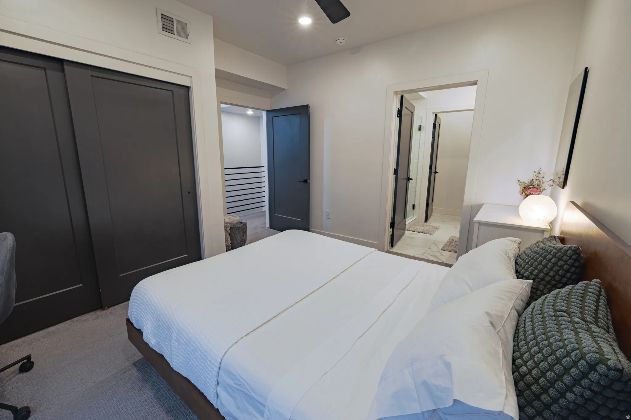 Primary Bedroom: Recessed lighting, wood-finish flooring, white walls, and dark tone doors
