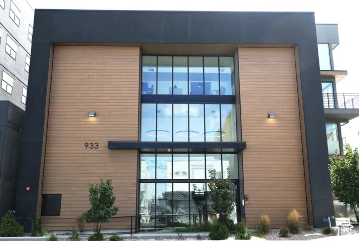 Modern exterior featuring wood-finish siding and expansive glass panels