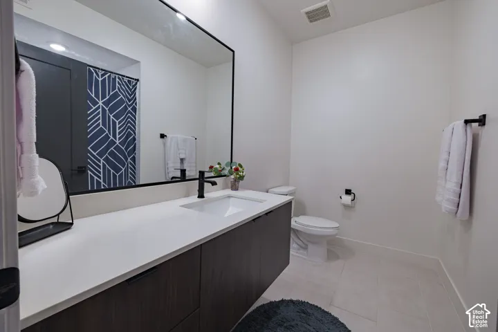 Spacious vanity with a white countertop and a single basin sink