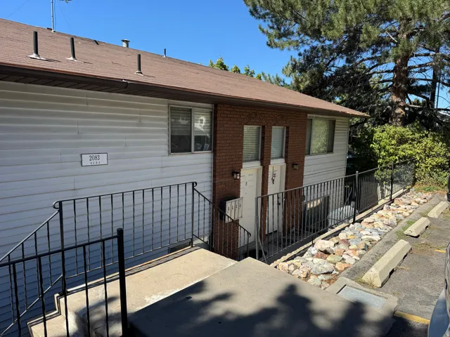 Building exterior featuring horizontal siding and brick accents