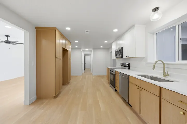 Kitchen featuring wood-finish flooring, recessed lighting, and stainless steel appliances