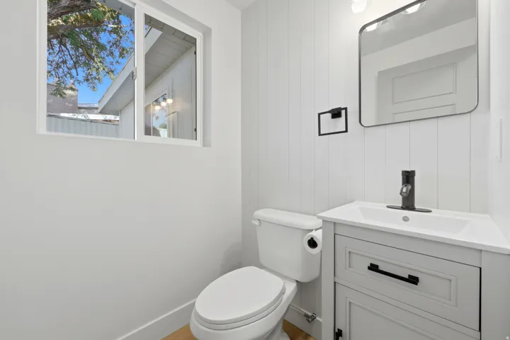 White toilet with a built-in toilet paper holder