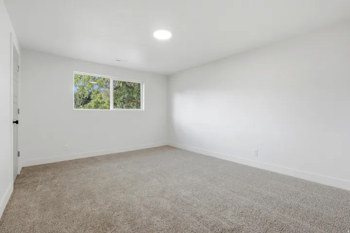 Neutral wall color, recessed lighting, double-paned window, and carpet flooring