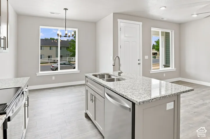 Kitchen island with dual stainless steel sink, granite-style countertop, and integrated dishwasher