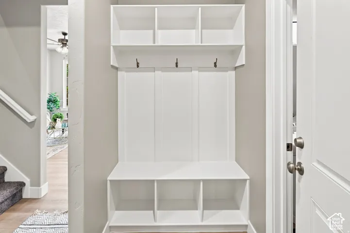 Built-in mudroom bench with cubbies, upper shelving, and coat hooks