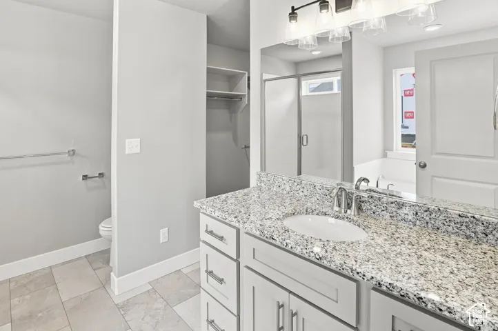 Picure of a similar finished unit. Bathroom vanity with a granite countertop, undermount sink, and chrome faucet