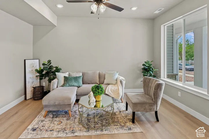 Recessed lighting, wood-finish flooring, ceiling fan, and large window