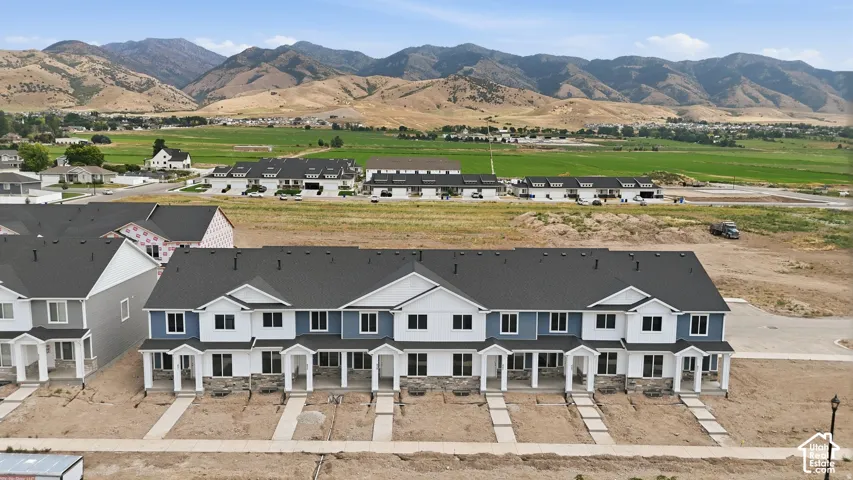 Terraced townhome-style residences with white siding and blue accents