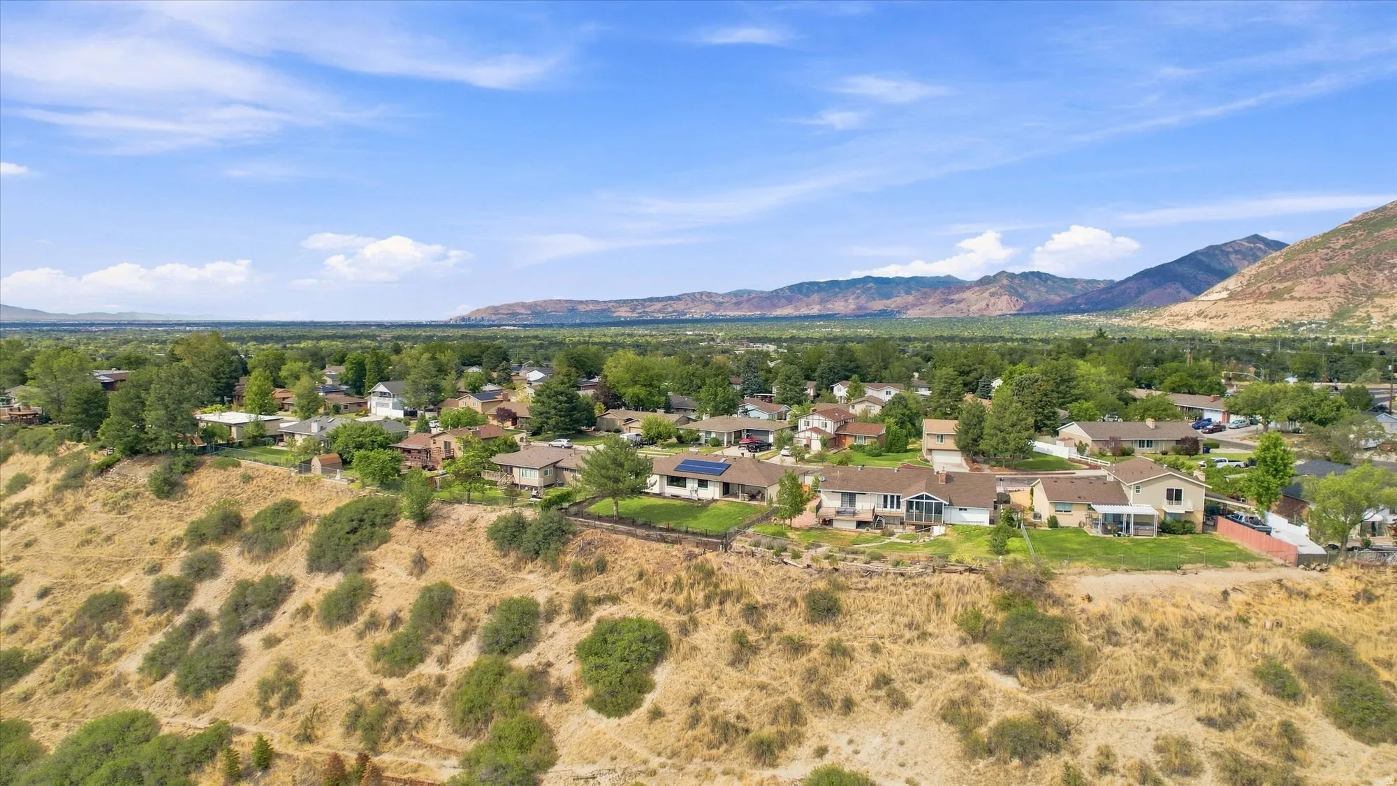 Residential neighborhood with a mountainous backdrop and established landscaping