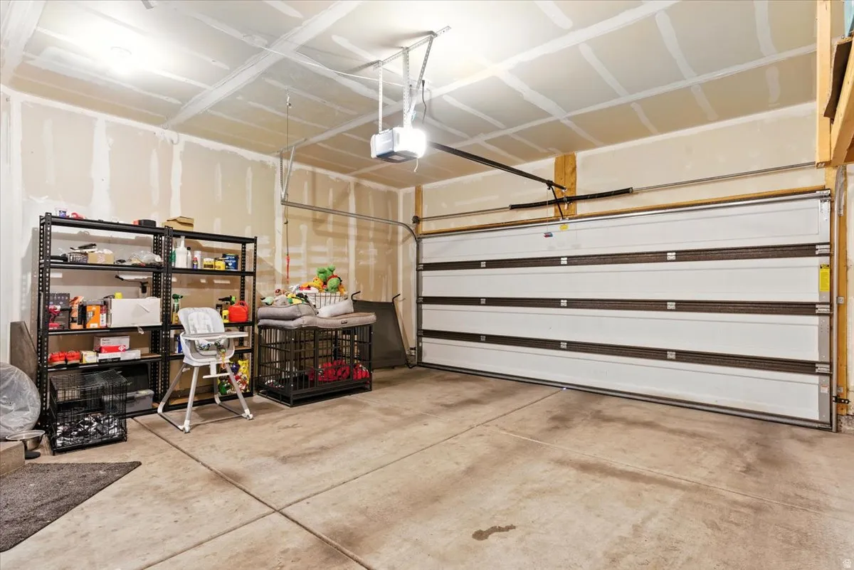 Concrete flooring, automatic garage door opener, and overhead lighting