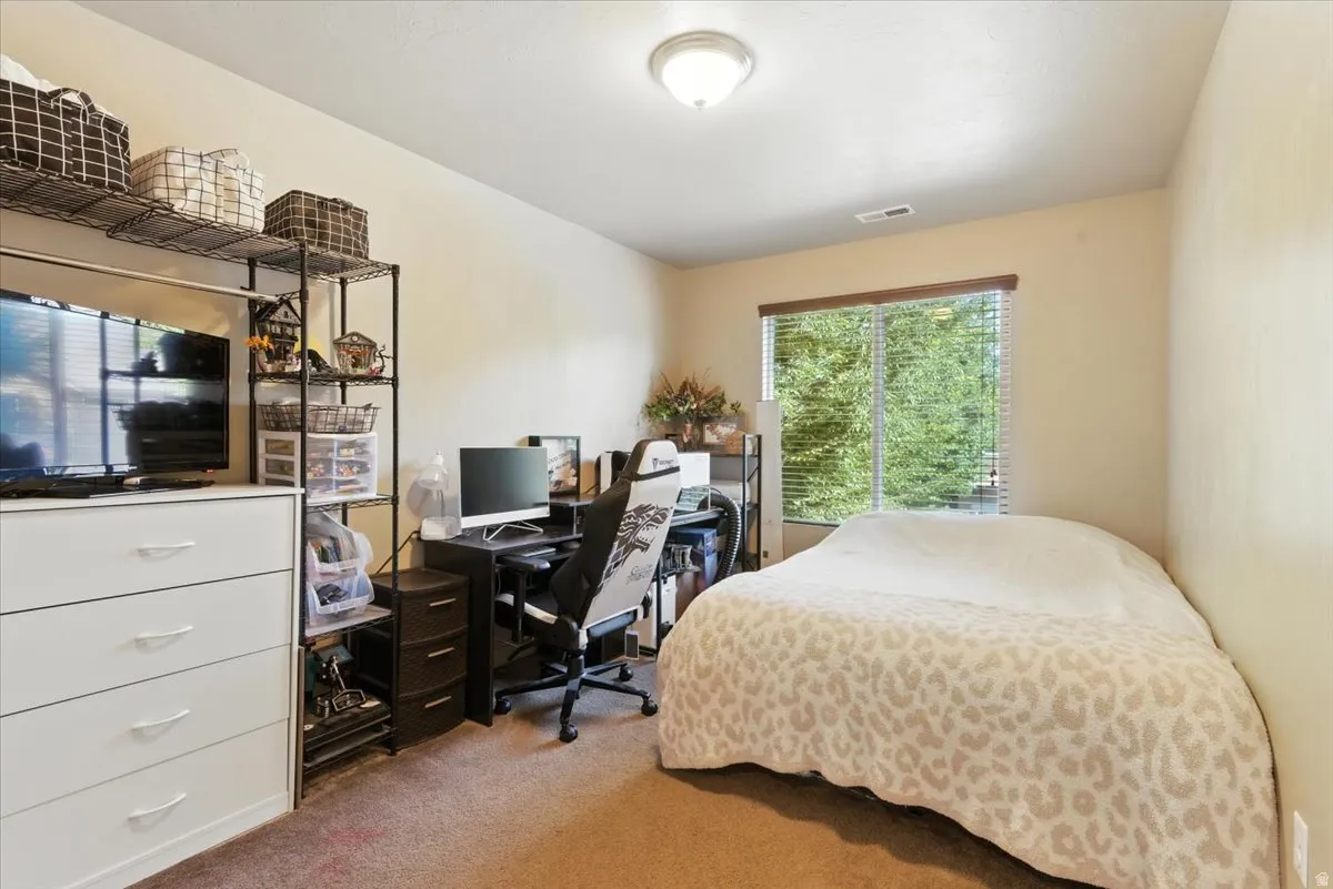 Recessed window with blinds, wall-to-wall carpeting, and an overhead flush-mount light fixture