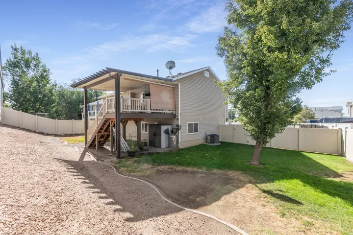 Two-story exterior with siding, a second-level deck with pergola, and an outdoor staircase