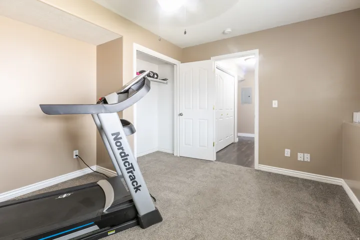 Carpeted flooring, neutral wall paint, white trim, and a ceiling fan