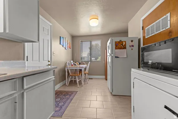 Tile flooring, recessed lighting, and a window with natural light