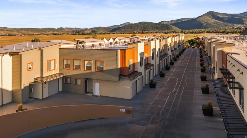 Modern townhome design featuring multiple architectural styles and attached garages