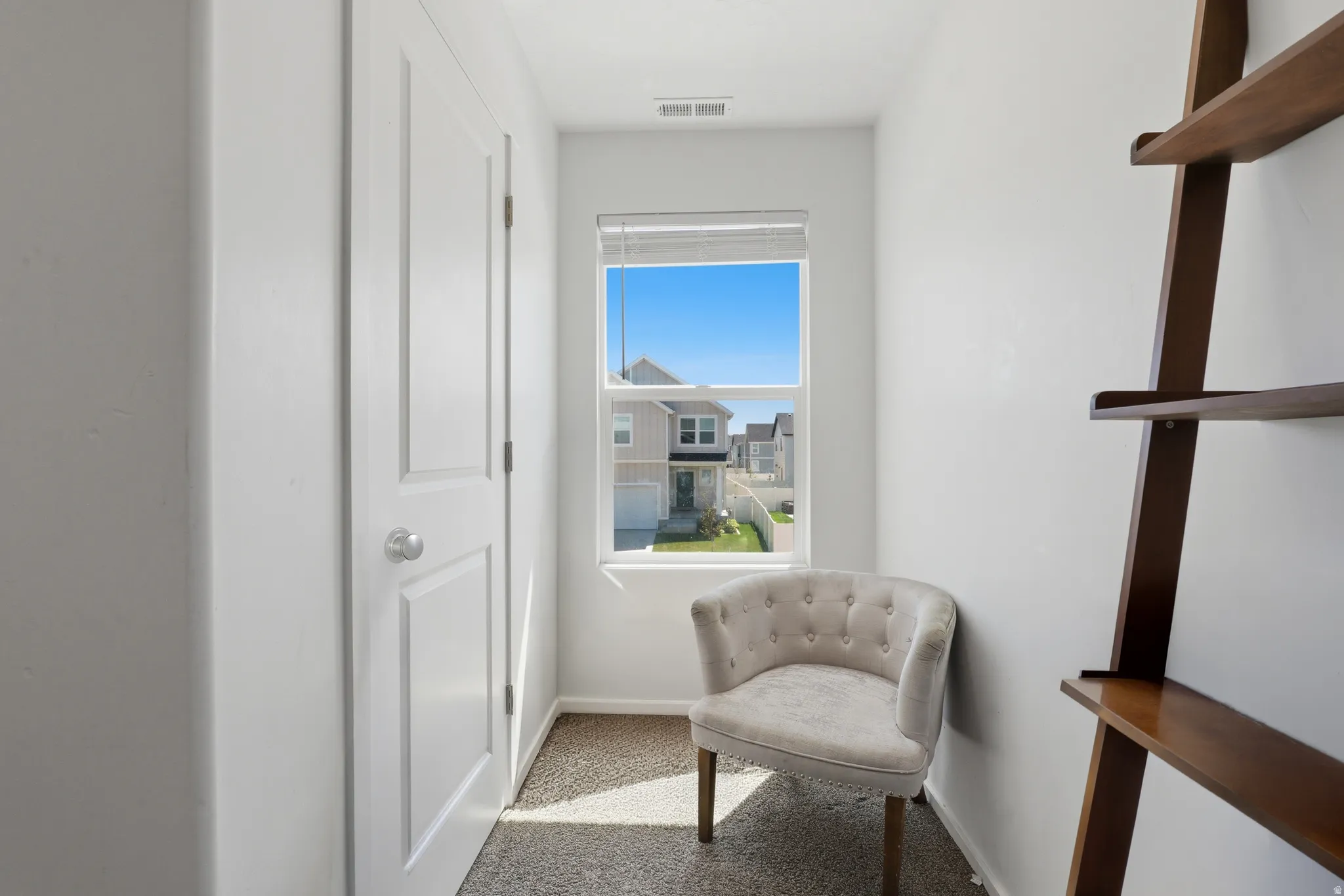 Recessed window with natural light, neutral wall colors, and wall-to-wall carpeting