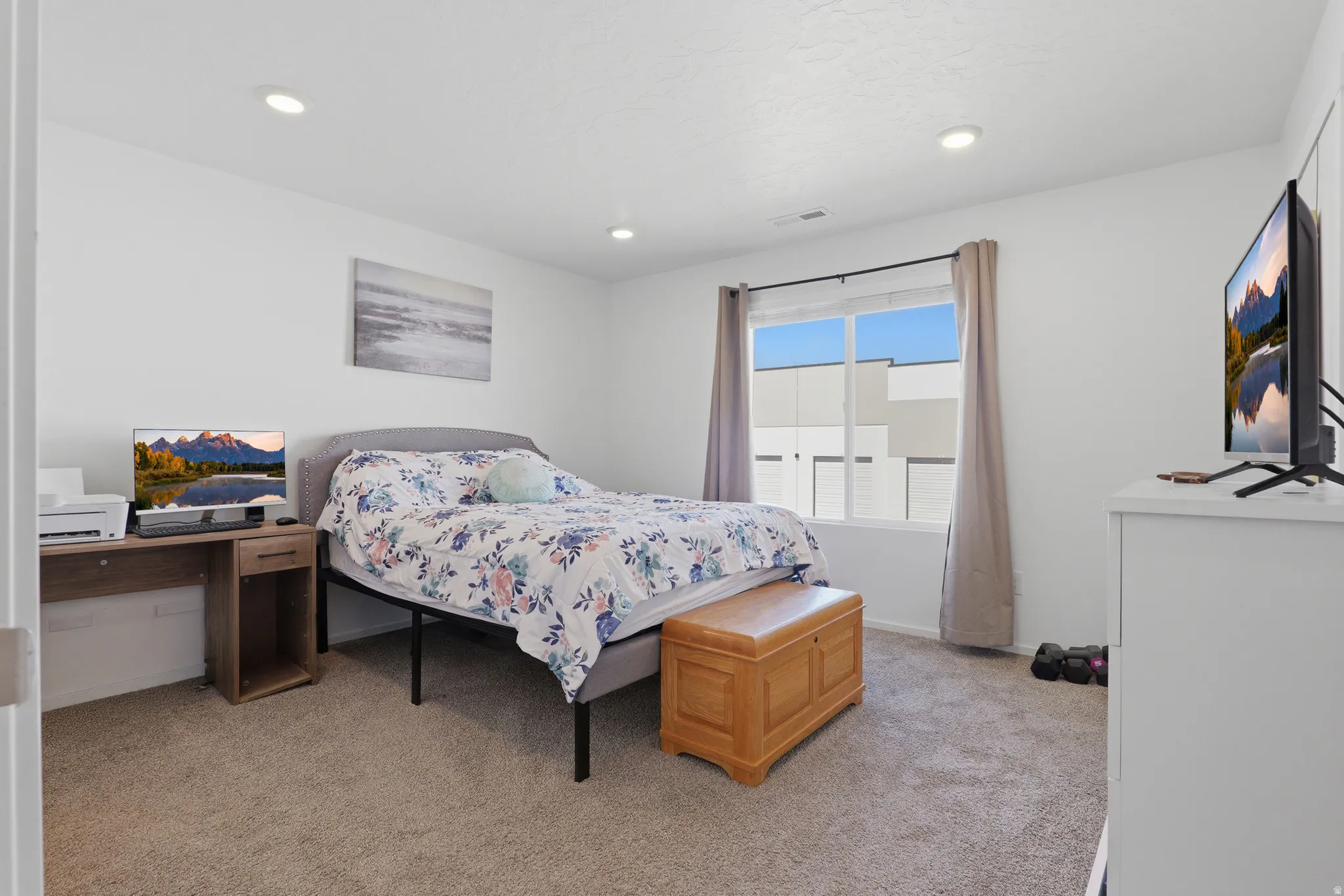 Recessed ceiling lighting, carpet flooring, and a large window with privacy blinds