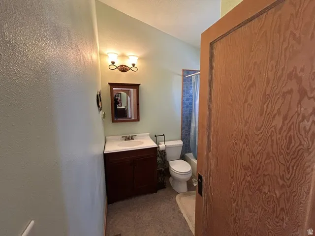 Built-in vanity with a white countertop and undermount sink