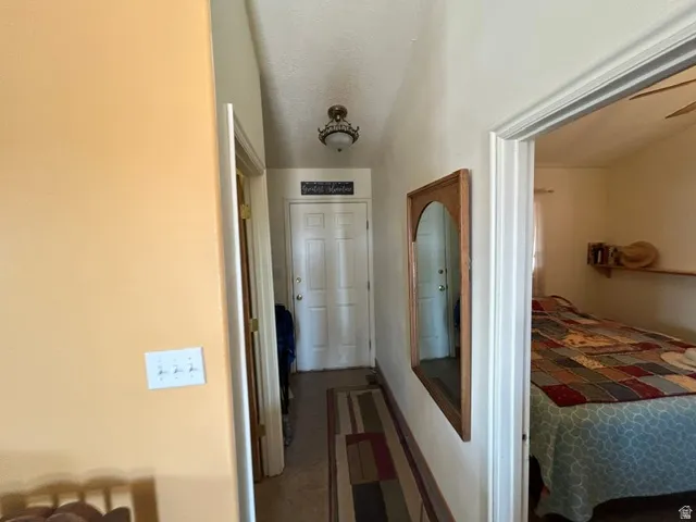 Entryway with a vaulted ceiling and overhead lighting