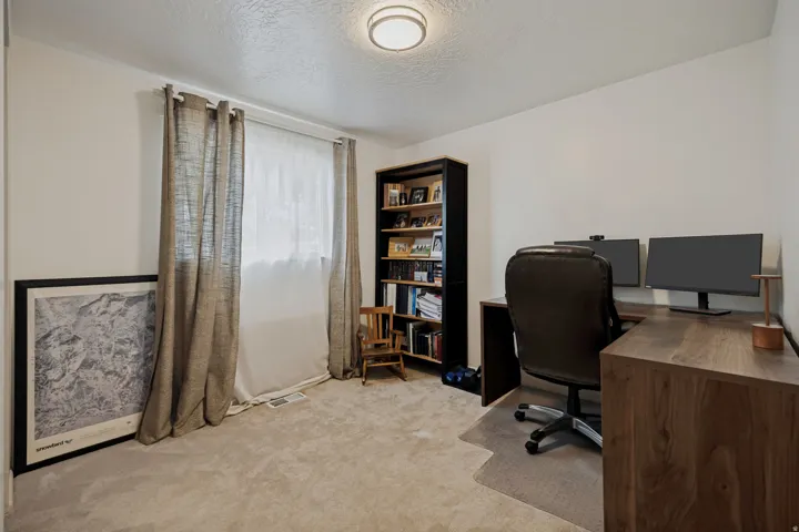 Bright room with neutral wall paint and light-colored carpeting