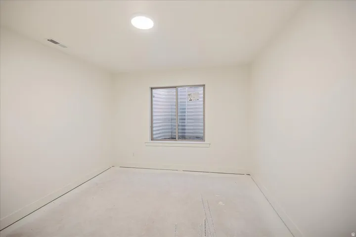 Recessed ceiling lighting and a window with white trim