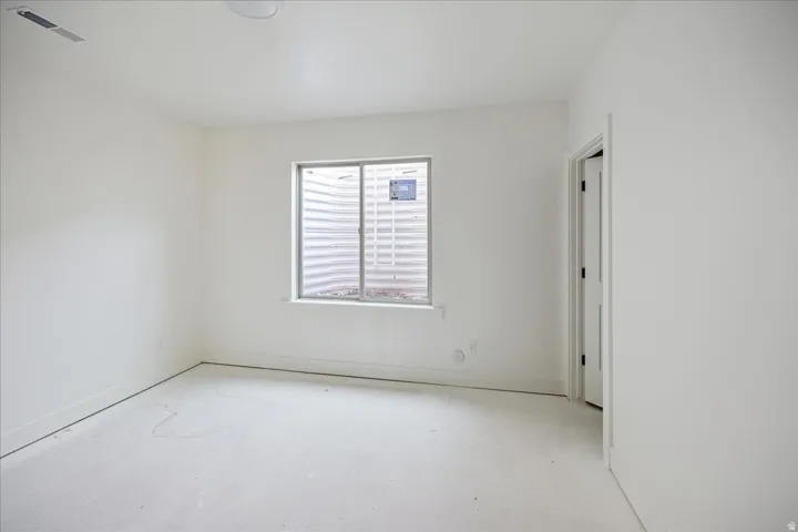 White painted walls and ceiling with a single window