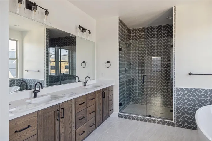 Dual vanity with undermount sinks and dark wood-finish cabinetry