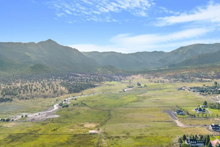 Expansive natural landscape featuring rolling hills and distant mountains