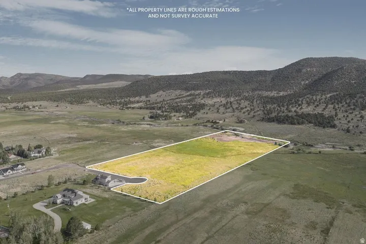 Expansive land parcel featuring open fields and distant mountain ranges