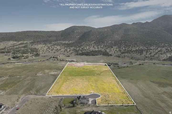 Expansive land parcel featuring open fields and distant mountains