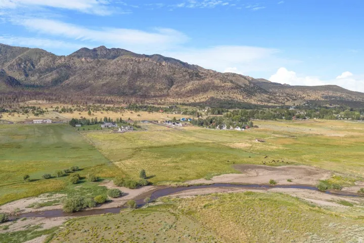Expansive natural landscape featuring rolling hills and distant mountains