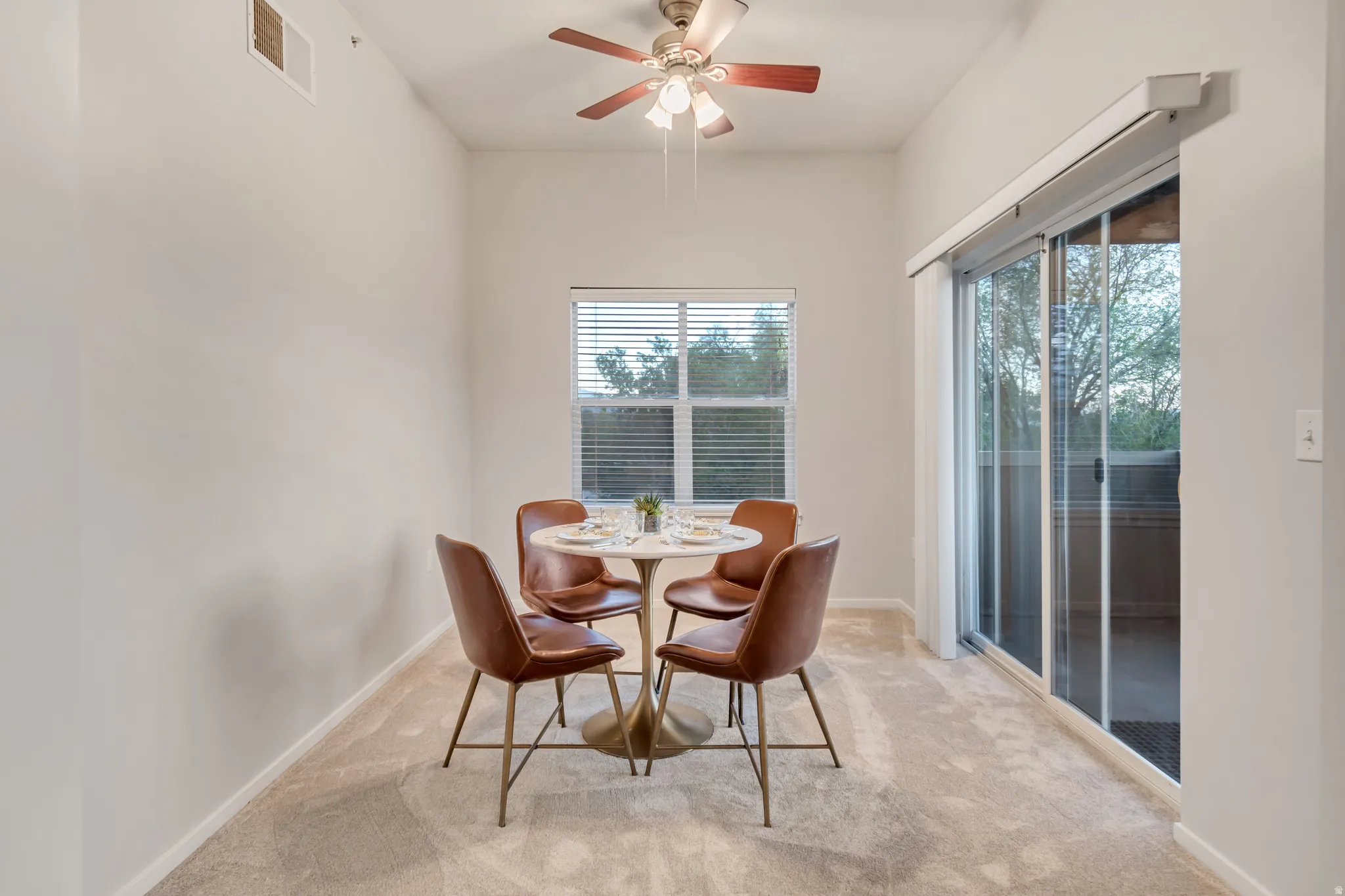 Recessed lighting, ceiling fan with wood-finish blades, carpet flooring, window with blinds, and sliding glass door