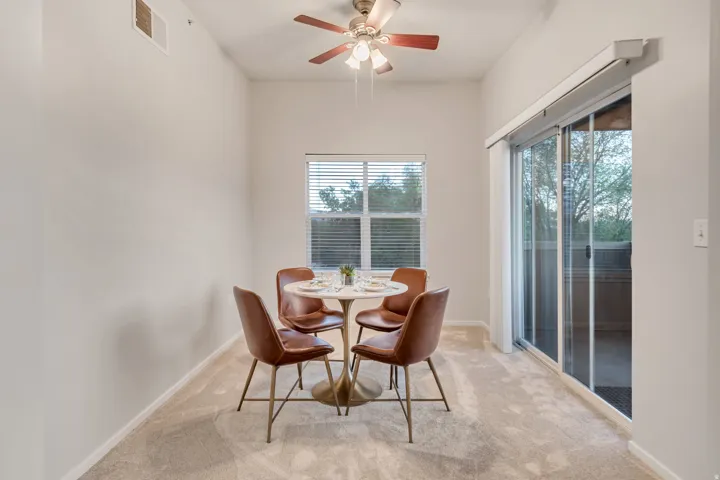 Recessed lighting, ceiling fan with wood-finish blades, carpet flooring, window with blinds, and sliding glass door