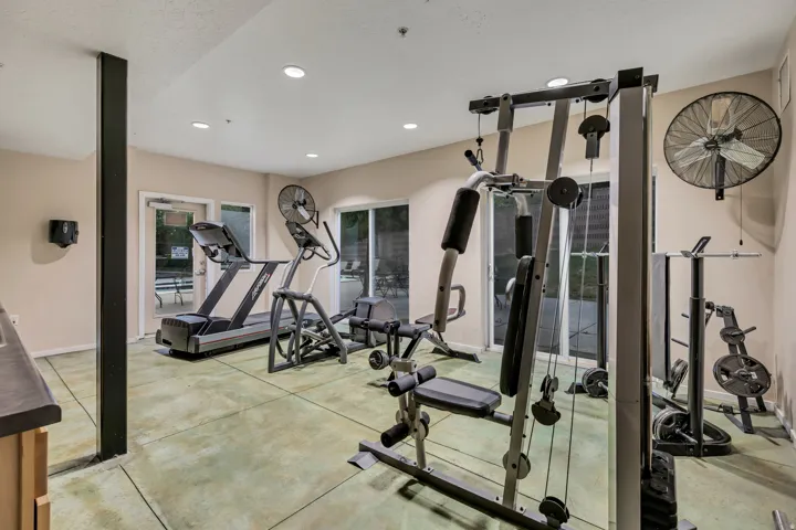 Fitness room featuring recessed lighting, a wall-mounted fan, and sliding glass doors