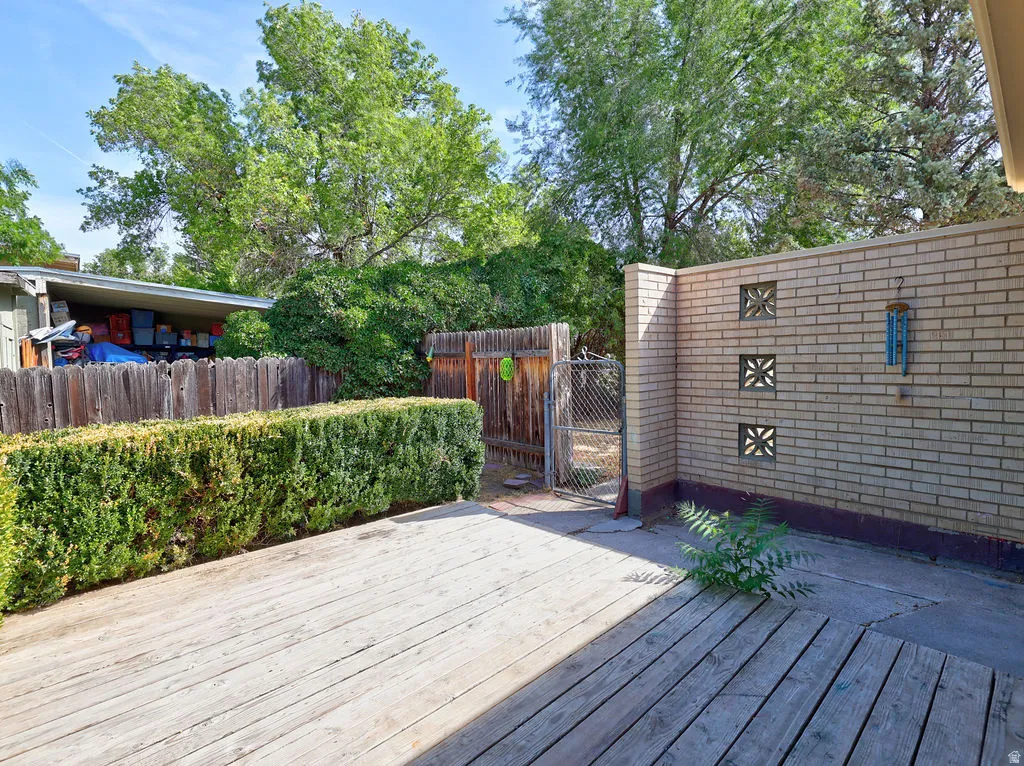 Wood-finish decking with brick wall featuring decorative blocks