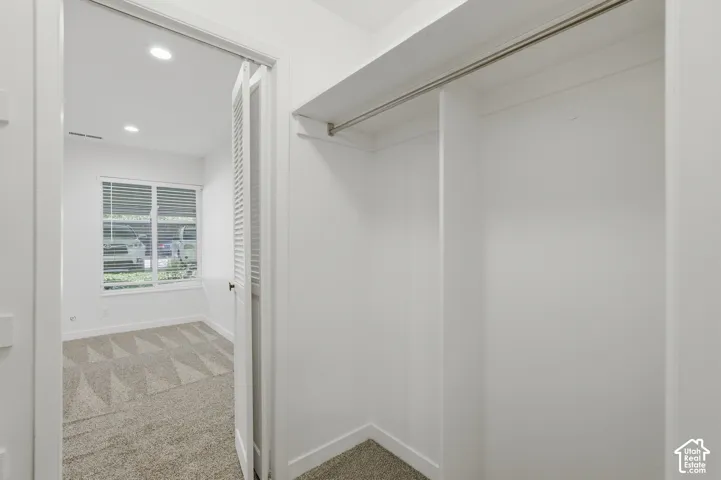 White-painted walls and trim with recessed lighting