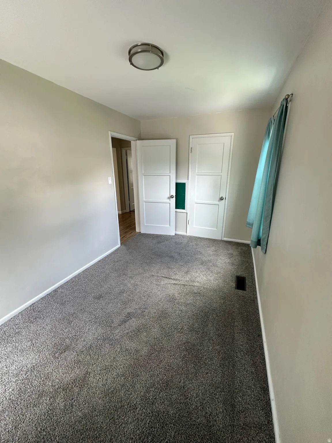 Plush gray carpeting and neutral wall tones