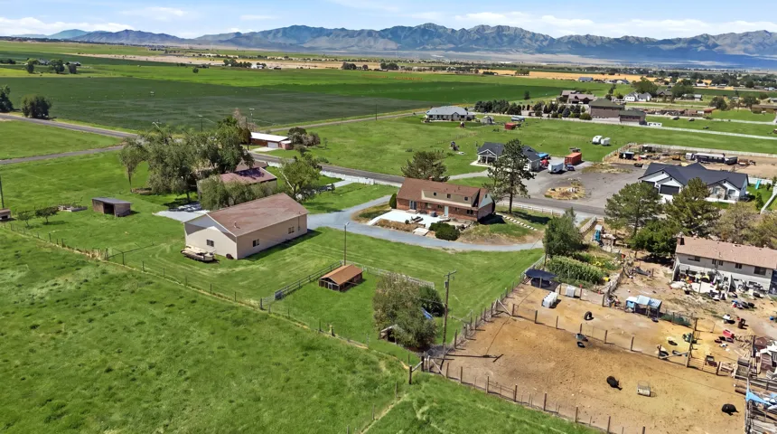 Expansive green spaces, multiple outbuildings, and a large residential structure with a light-colored roof