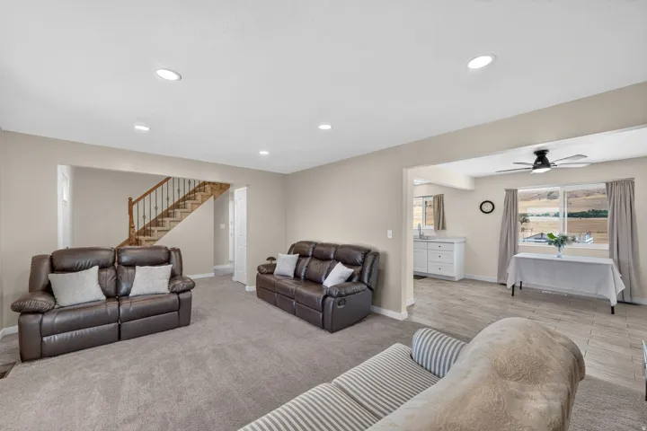 Spacious living area with recessed lighting and neutral-toned walls
