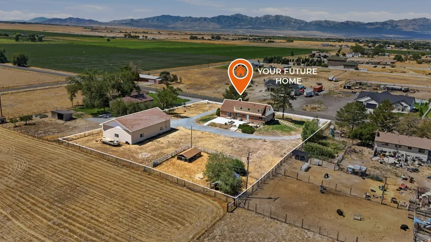 Spacious parcel featuring a primary residence, a large detached outbuilding, and expansive open land with fencing