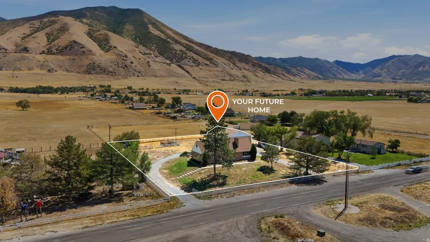 Expansive property featuring a two-story residence, mature trees, and a paved driveway