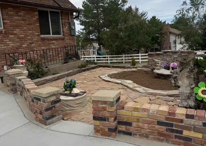 Brick exterior with a stone-paved patio area
