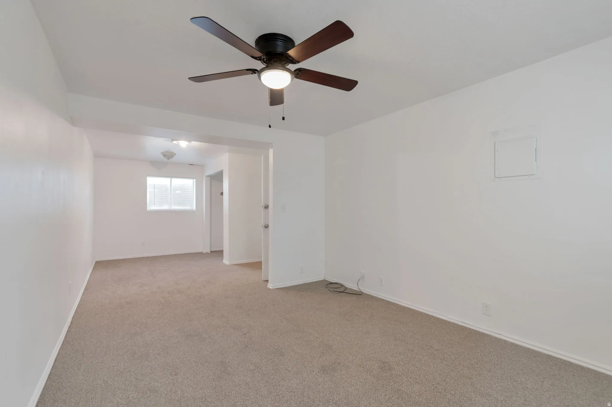 Ceiling fan with integrated lighting, neutral-toned carpet flooring, white painted walls, and window with horizontal blinds