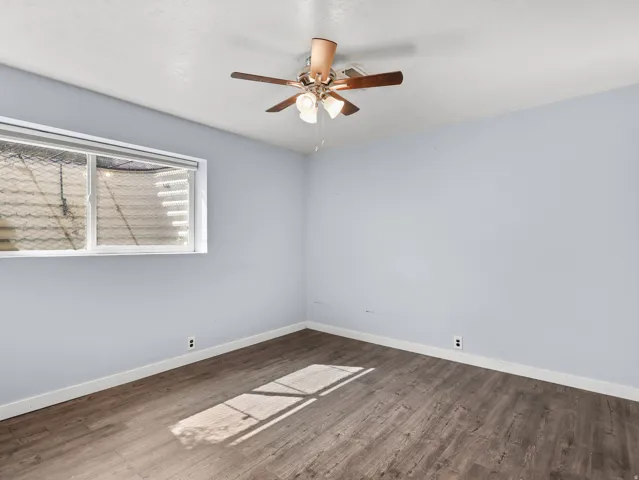Wood-finish flooring, light gray walls, and a white ceiling