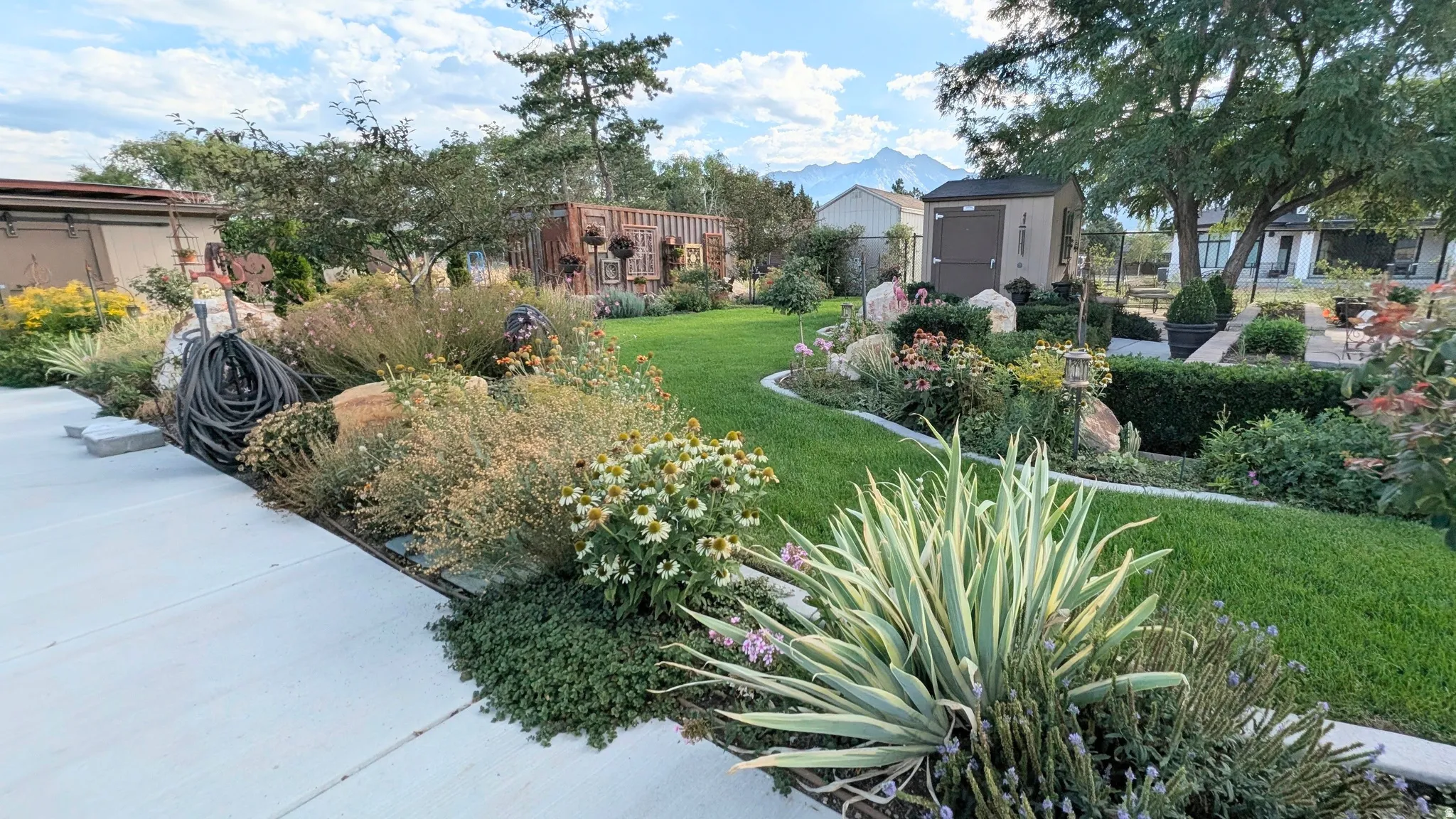 If you've ever dreamed about living at Red  Butte Gardens or Thanksgiving Point, this is a home you won't want to miss! Photo of part of the stunning backyard + outbuildings (greenhouse + sheds)