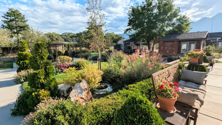 If you've ever dreamed about living at Red  Butte Gardens or Thanksgiving Point, this is a home you won't want to miss! Photo of the stunning backyard + out buildings (greenhouse + sheds).